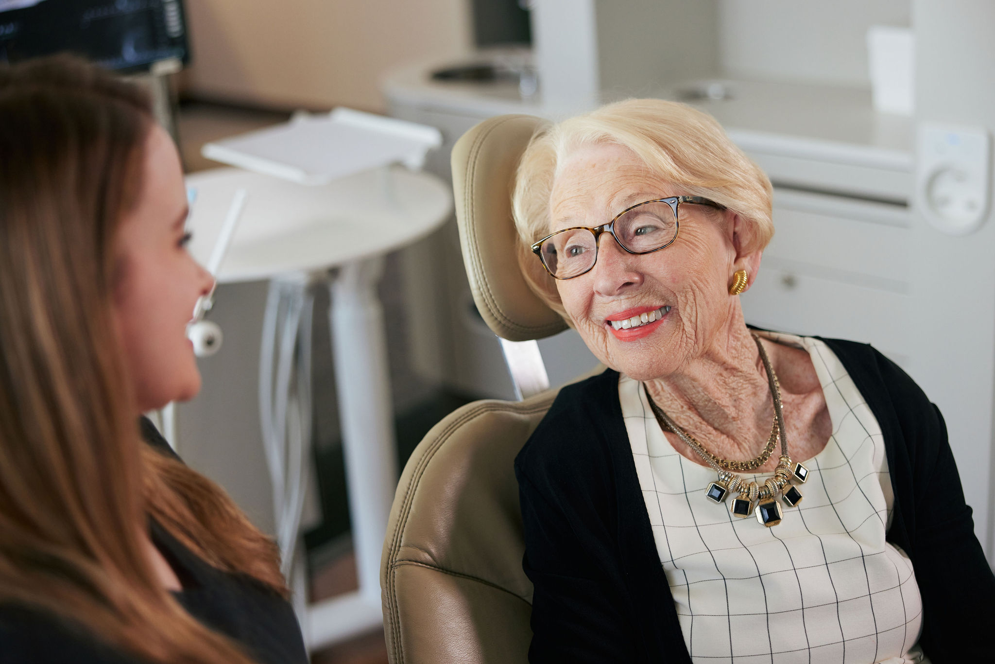 An elderly dental patient consulting with a dentist
